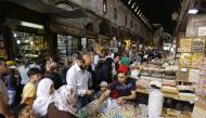 Syrians shop at the Hamidiyeh popular market in the old part of the capital Damascus as they prepare for the Muslim Eid al-Adha holiday on September 11, 2016. / AFP / LOUAI BESHARA