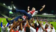 Al Rayyan players throw coach Jorge Fossati in the air during the celebrations after winning the Qatar Stars League in this file photo.