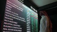 File photo of an investor monitoring a screen displaying stock information at the Saudi Stock Exchange (Tadawul) in Riyadh, Saudi Arabia. Faisal Nasser / Reuters.
