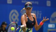 Kristina Mladenovic of France hits a return during her second round match against Angelique Kerber of Germany at the WTA Wuhan Open in Wuhan, in China's central Hubei province on September 27, 2016. / AFP / GREG BAKER
