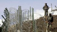 This file photograph shows Indian soldiers as they patrol along a barbed-wire fence near Baras Post on the Line of Control (LoC) between Pakistan and India some 174 kms north west of Srinagar. AFP / SAJJAD HUSSAIN