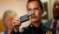 Police Chief Jeff Davis holds up a vape similar to the one held by Alfred Olango after police released video showing the the death of Alfred Olango, who was shot by El Cajon police Tuesday, at the El Cajon Police Department headquarters in El Cajon, Calif