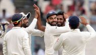 India's Bhuvneshwar Kumar (R) with teammates including captain Virat Kohli celebrate after the wicket of New Zealand's Matt Henry during the second day of the second Test match between India and New Zealand at The Eden Gardens Cricket Stadium in Kolkata o