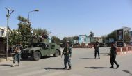 Afghan policeman stand alert during fighting between Taliban militants and Afghan security forces in Kunduz on October 3, 2016. AFP / BASHIR KHAN SAFI