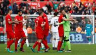 Liverpool players celebrate after the game. (Reuters / Stefan Wermuth)
