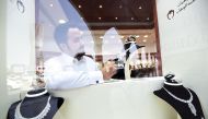 A Saudi vendor adjusts diamonds accessories at his jewelry shop at Tiba market in Riyadh, on October 3, 2016. (AFP / Fayez Nureldine)