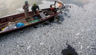 Workers collect dead fishes floating in the polluted West Lake in Hanoi, Vietnam on October 2, 2016. (Photo: Reuters)