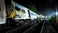 Emergency responders work near a train that sits derailed near the community of New Hyde Park on Long Island in New York, US, October 9, 2016. Reuters/Eduardo Munoz
