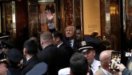 Republican presidential nominee Donald Trump waves to supporters outside the front door of Trump Tower where he lives in the Manhattan borough of New York, US. Reuters/Mike Segar

