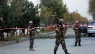 Afghan security personnel stand guard at the site of suicide attack in Kabul, Afghanistan, Wednesday, Oct. 5, 2016. (AP Photo/Rahmat Gul).