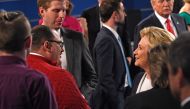 In this file photo dated October 9, 2016 US Democratic Presidential nominee Hillary Clinton (R) shakes hands with Ken Bone following the second presidential debate with Republican nominee Donald Trump (far R background) at Washington University in St. Lou