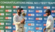 India's Test cricket team captain Virat Kohli holds the ICC Number 1 Test cricket team trophy after winning the three Test cricket match series against New Zealand at the Holkar Cricket Stadium in Indore on October 11, 2016. (AFP / Punit Paranjpe)