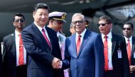 Chinese President Xi Jinping (L) is greeted by Bangladesh's President Abdul Hamid after arriving in Dhaka on October 14, 2016. AFP 