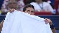 Novak Djokovic of Serbia looks on during a break in the men's singles semifinals match against Roberto Bautista Agut of Spain at the Shanghai Masters tennis tournament in Shanghai on October 15, 2016. / AFP / WANG ZHAO