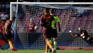 AS Roma's Edin Dzeko (L) shoots to score. REUTERS/Max Rossi
