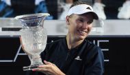 Denmark's Caroline Wozniacki holds the trophy as she celebrates victory against France's Kristina Mladenovic after their women's final match at the Hong Kong Open tennis tournament on October 16, 2016. / AFP / Anthony WALLACE
