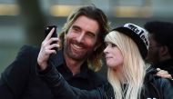 Sharlto Copley poses for a photograph with a fan as he arrives for the gala screening of the film 