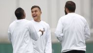 Juventus' forward Paulo Dybala from Argentina (2nd L), defender Patrice Evra from France (L) and forward Gonzalo Higuain from Argentina take part in a training session on the eve of a UEFA Champions League football match against Olympique Lyonnais on Octo