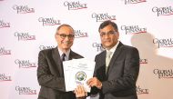 Ali Khan (right), Head of Financial Institutions, receiving the award on behalf of QIB. 
