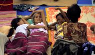 Evacuees from the coastal villages take shelter inside an evacuation center as Typhoon Haima locally name Lawin approaches, in Alcala town, Cagayan province, north of Manila October 19, 2016. REUTERS