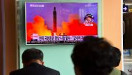 People watch a television news report showing file footage of North Korea's missile launch at a railway station in Seoul on October 20, 2016. AFP / JUNG YEON-JE