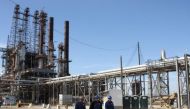 Refinery workers walk inside the LyondellBasell oil refinery in Houston, Texas March 6, 2013. Reuters/Donna Carson/File Photo