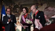 American collectors Marlene (C) and Spencer (R) Hays pose for a photograph after they have been awarded Chevalier de la Legion d'Honneur (Knight of the Legion of Honour) by French President Francois Hollande (L) following their donation of painting master