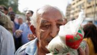 A man carries subsidized sugar after buying it from a government truck during a sugar shortage in retail stores across the country in Cairo, Egypt, October 14, 2016. Picture taken October 14, 2016. REUTERS/Amr Abdallah Dalsh