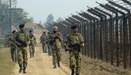 A file photo of Indian Border Security Force soldiers patrolling along the India-Pakistan border fence about 27km from Wagah. Photo: AFP.