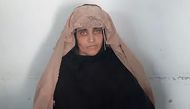 In this handout photograph released by Pakistan's Federal Investigation Agency (FIA) on October 26, 2016, Afghan Sharbat Gula, the 'Afghan Girl' who appeared on the cover of a 1985 edition of National Geographic magazine, waits ahead of a court hearing in