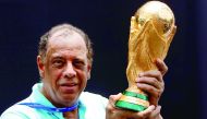 Former Brazilian soccer captain Carlos Alberto Torres holds the 2014 FIFA World Cup Brazil trophy during its unveiling ceremony at a Soccerex event at Copacabana beach in Rio de Janeiro in this November 21, 2010 file photo.
