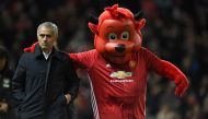 Manchester United's Portuguese manager Jose Mourinho arrives with Fred the Red, United's official mascot, ahead of the EFL (English Football League) Cup fourth round match between Manchester United and Manchester City at Old Trafford in Manchester, north 