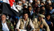 Followers sit along a street as they watch Abdul-Malik al-Houthi, leader of the Houthi movement, deliever a speech on a screen during a rally commemorating the death of Imam Zaid bin Ali in Sanaa, Yemen October 26, 2016. REUTERS/Khaled Abdullah