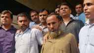 Plain-clothes policemen present two Indian men (bottom 2nd R and 2nd L), who they said are accused of spying for Pakistan, before the media inside the police headquarters in New Delhi, India, October 27, 2016. REUTERS