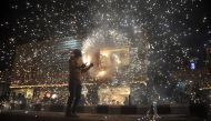 An Indian worker bursts firecrackers during a fireworks display at a local marketplace on the eve of Diwali festival in Jammu. AFP / STRINGER