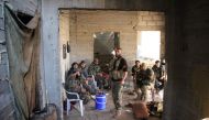 Rebel fighters from the Jaish al-Fatah (or Army of Conquest) brigades have a tea in a building under construction on October 29, 2016 in the neighbourhood of Dahiyet al-Assad, southwest of Aleppo, after they retook control of the area./ AFP / Omar haj kad