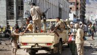 Yemeni security forces gather at the site where a suicide car bomb exploded next to the central bank in Yemen's second city Aden on October 29, 2016. 