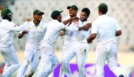 Bangladesh's Shakib Al Hasan (2R) celebrates with teammates after taking the wicket of England's Zafar Ansari during the third day of the second Test cricket match Bangladesh and England at the Sher-e-Bangla National Cricket Stadium in Dhaka on October 30
