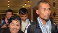 Cambodian seafarers released after being held hostage by Somali pirates are surrounded by media after arriving at Phnom Penh International Airport on October 30, 2016. The seafarers are among 26 hostages freed from the crew of Naham 3 seized south of the 