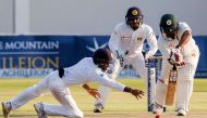 Zimbabwe's batsman Tinotenda Mawoyo plays a shot in front of Sri Lanka's wicketkeeper Kusal Janith Perera during the second day's play in the first cricket Test match between Sri Lanka and hosts Zimbabwe at the Harare Sports Club on October 30 2016. This 