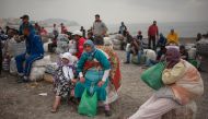 People await on the beach before crossing the El Tarajal border, separating Morocco and Spain's North African enclave of Ceuta, in Ceuta on October 27, 2016. (AFP / JORGE GUERRERO) 