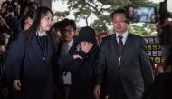 Choi Soon-Sil (C) is escorted as she arrives at the Seoul Central District Prosecutor's Office in Seoul on October 31, 2016. AFP / Ed Jones