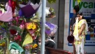 A woman reacts as she looks at a floral tribute for a bus driver that was murdered last Friday in Brisbane, Australia, October 30, 2016. AAP/Dan Peled/REUTERS 
