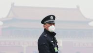 A policeman, wearing a mask to protect from severe pollution, secures the area near the Great Hall of the People before the opening session of the Chinese People's Political Consultative Conference (CPPCC) in Beijing, China, March 3, 2016. REUTERS/Kim Kyu