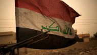 Iraq's flag is seen during a sand storm in Bartilla, east of Mosul, Iraq November 1, 2016. (REUTERS/Zohra Bensemra) 