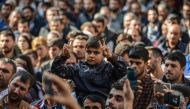 A young participant flashes the victory sign in front of the municipality headquarters in Diyarbakir, southeastern Turkey, on October 30, 2016, during a pro-Kurdish demonstration. A Turkish court has barred Figen Yuksekdag, a leader of the main pro-Kurdis