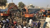 Rescuers workers use heavy machinery on the car of a train which crashed outside Karachi, Pakistan November 3, 2016. Reuters/Akhtar Soomro

