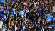 US Democratic presidential nominee Hillary Clinton (R-blue) waves at supporters during a campaign rally in Tempe, Arizona, on November 2, 2016. AFP / Jewel Samad
