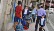 A boy walks back home alone after a day at school in the center of Pontevedra, northwestern Spain, on September 22, 2016.   AFP / MIGUEL RIOPA
