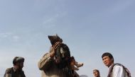 An Afghan man carries the dead body of a child following a NATO coalition airstrike on the outskirts of Kunduz on November 3, 2016. 30 Afghan civilians were killed in an airstrike in Kunduz, Afghan officials said on November 3. (AFP / BASHIR KHAN SAFI)
